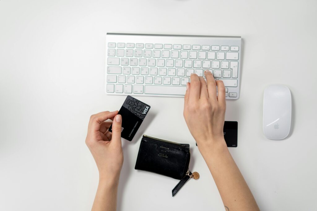 Women using credit card keyboard with a credit card in her hand