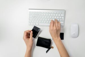 Women using credit card keyboard with a credit card in her hand
